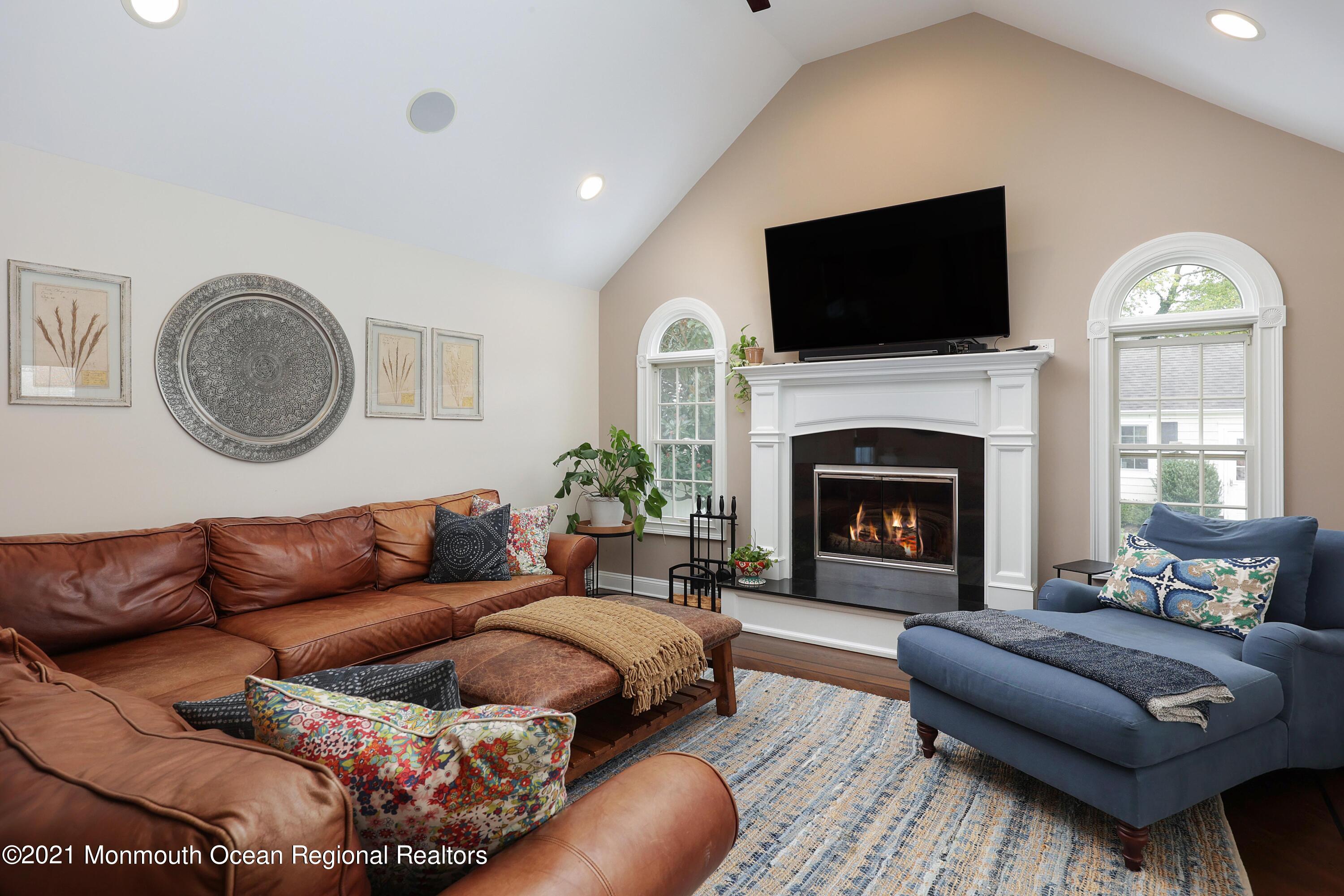 57 River Road Rumson, NJ 07760 - Photo 13 of 34 a living room with furniture a fireplace and a flat screen tv