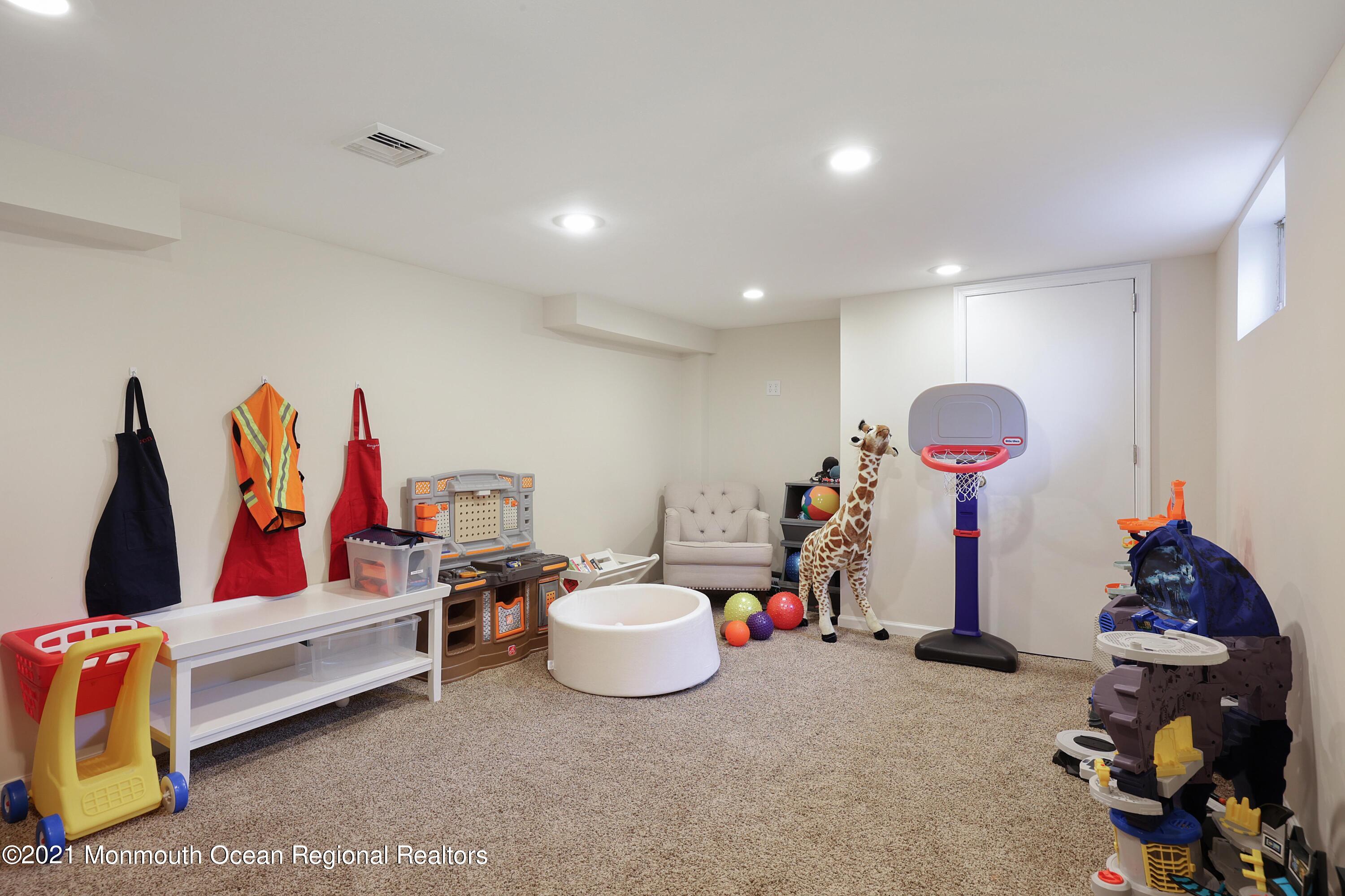 57 River Road Rumson, NJ 07760 - Photo 14 of 34 a living room with furniture and a gym equipment