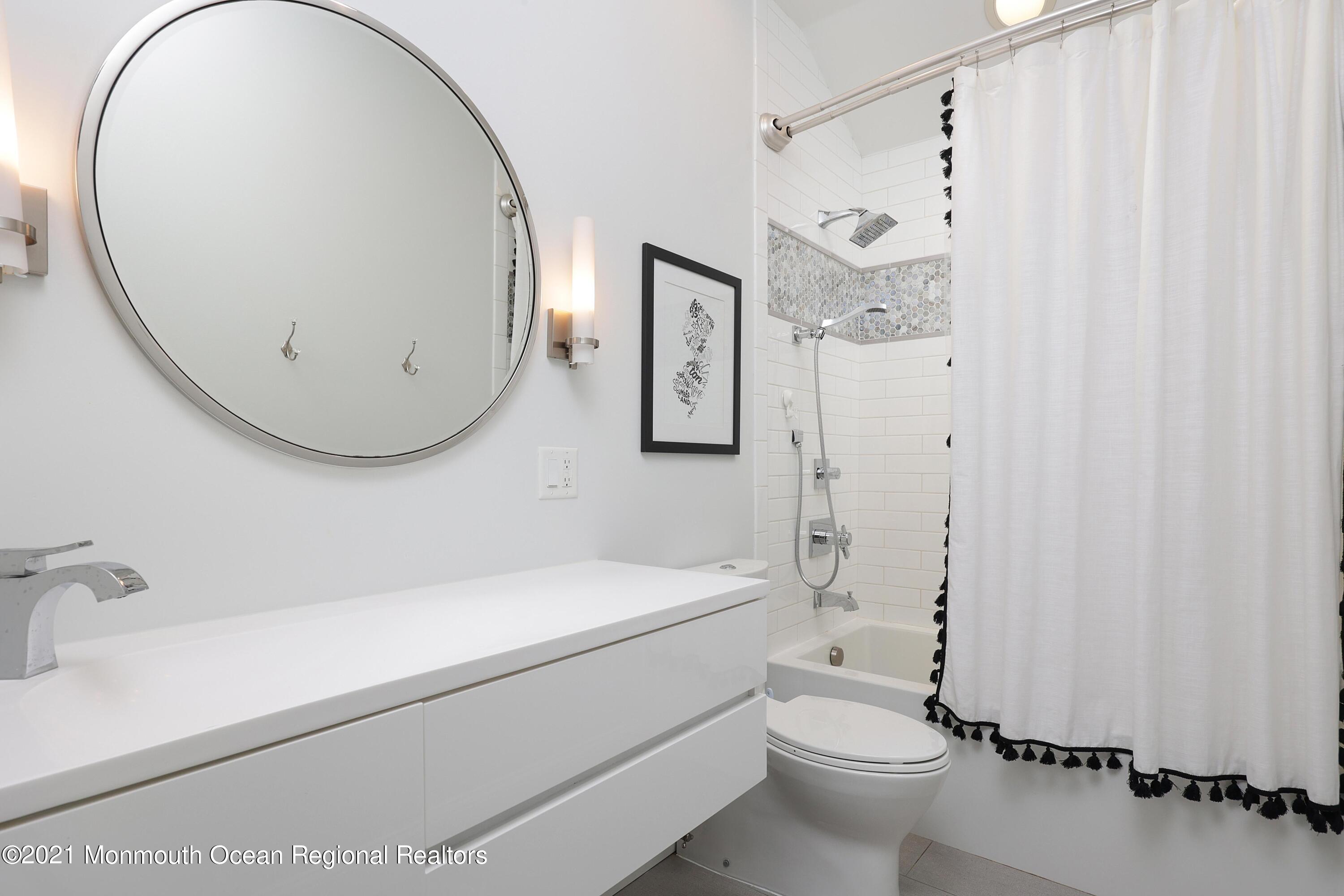 57 River Road Rumson, NJ 07760 - Photo 17 of 34 a bathroom with a sink a toilet and a mirror