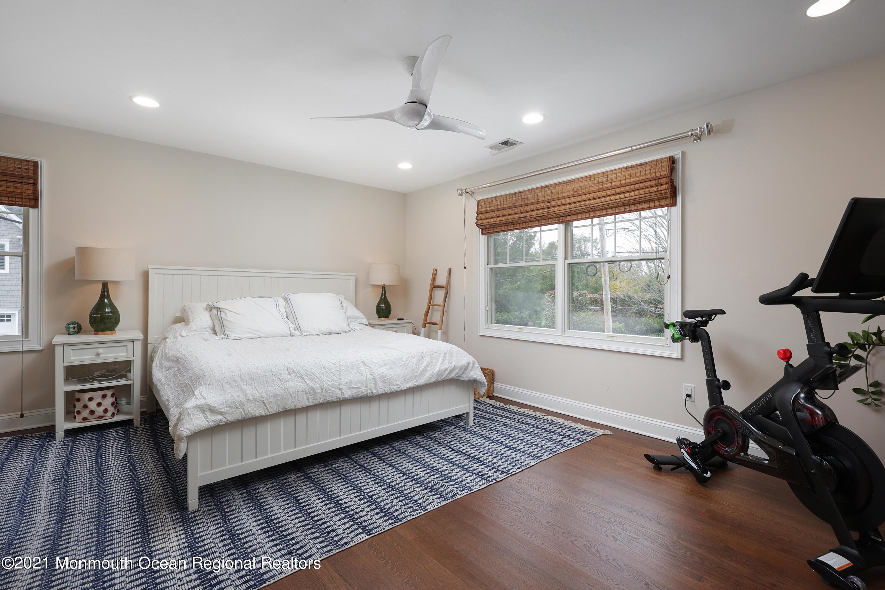 57 River Road Rumson, NJ 07760 - Photo 18 of 34 a bedroom with a bed and wooden floor