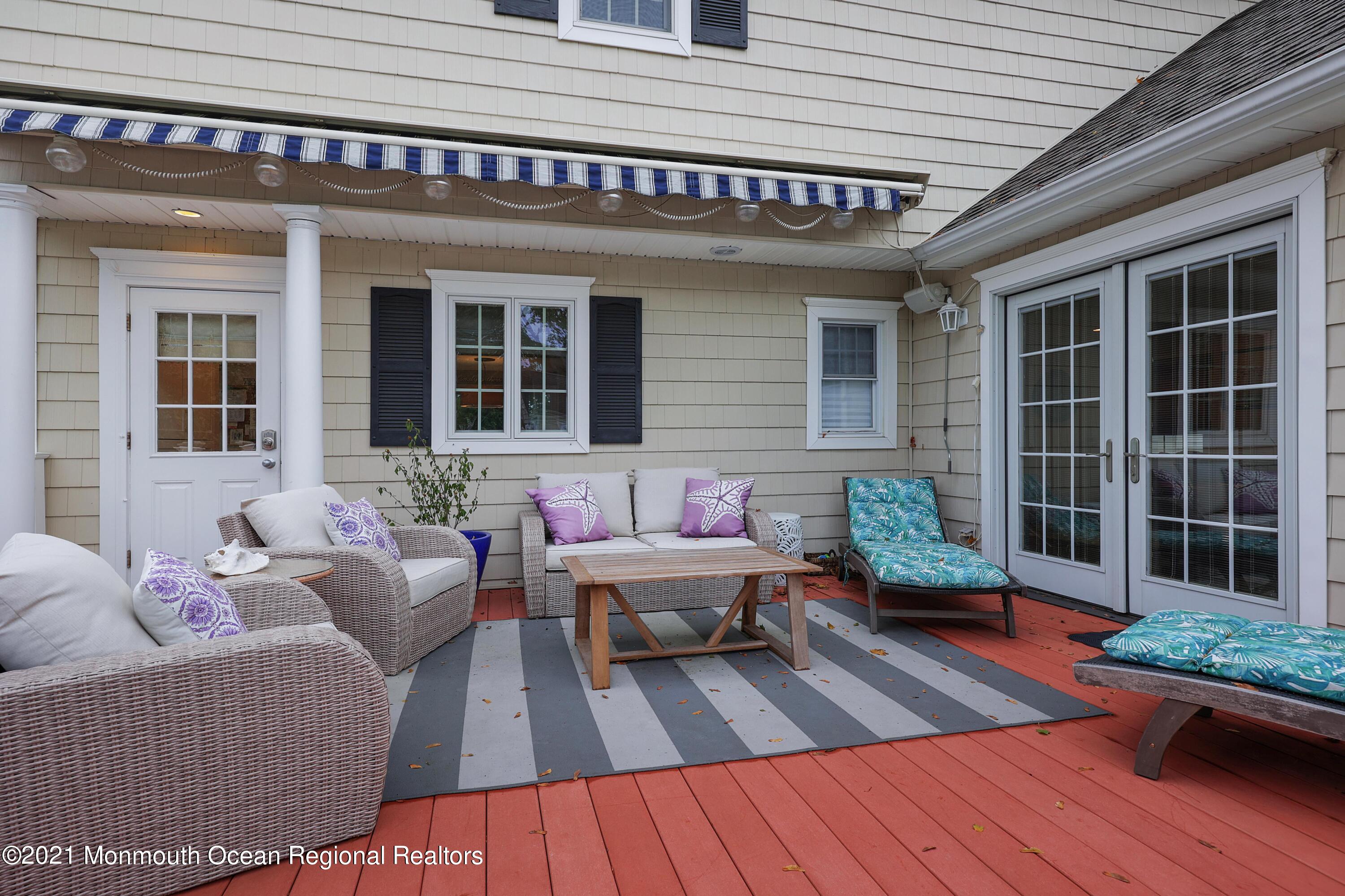57 River Road Rumson, NJ 07760 - Photo 19 of 34 a balcony with furniture and wooden floor