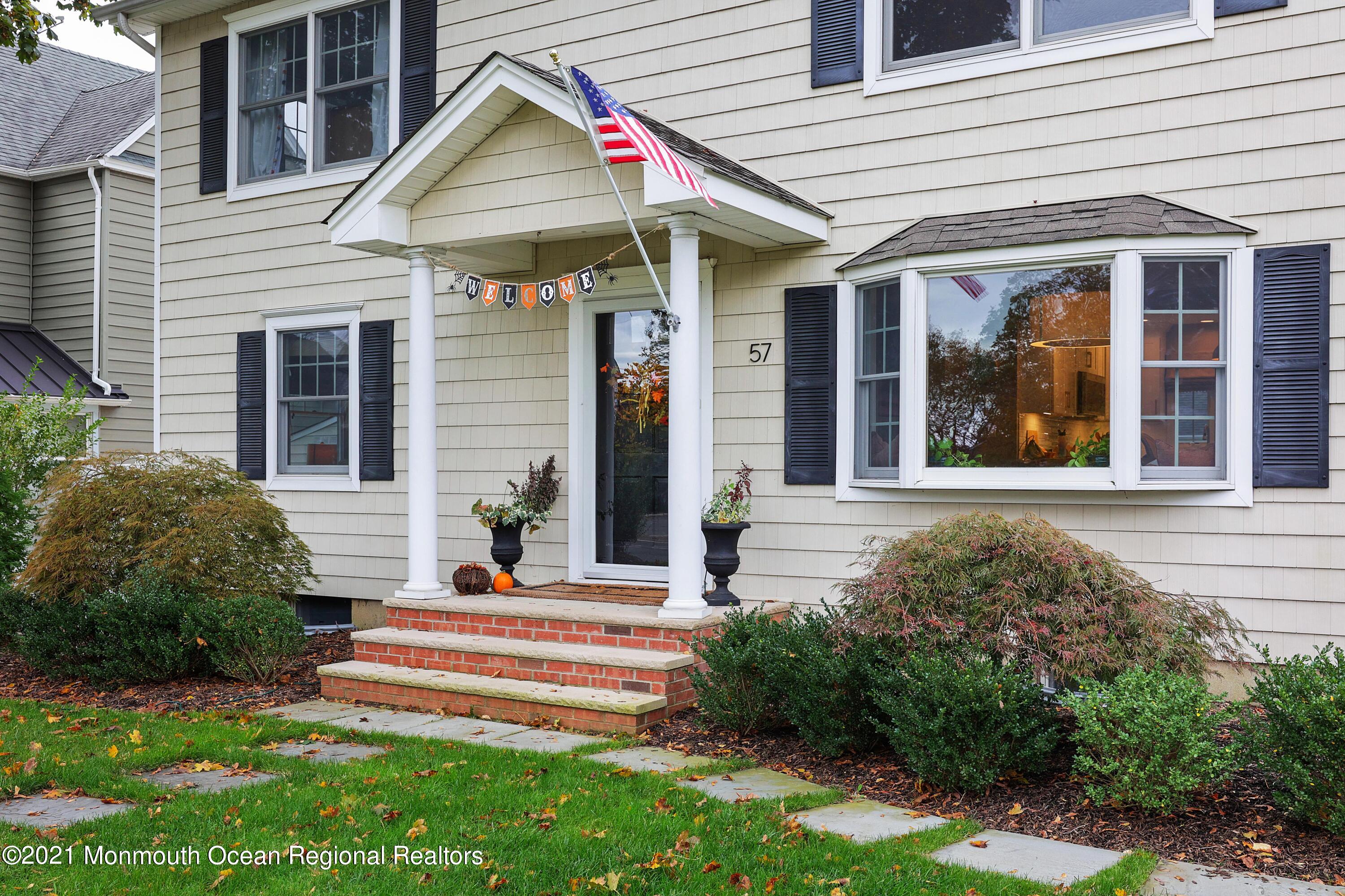 57 River Road Rumson, NJ 07760 - Photo 2 of 34 a front view of a house with a yard
