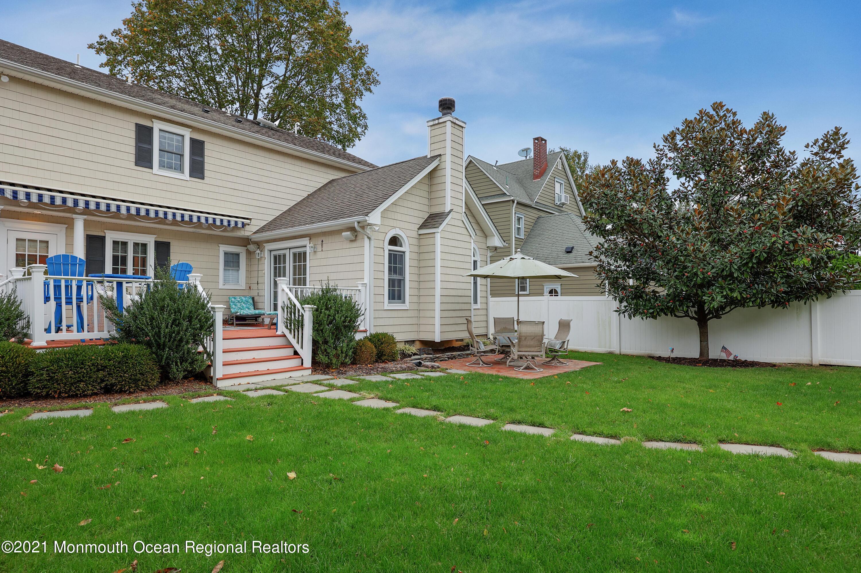 57 River Road Rumson, NJ 07760 - Photo 22 of 34 a view of a house with a yard and sitting area