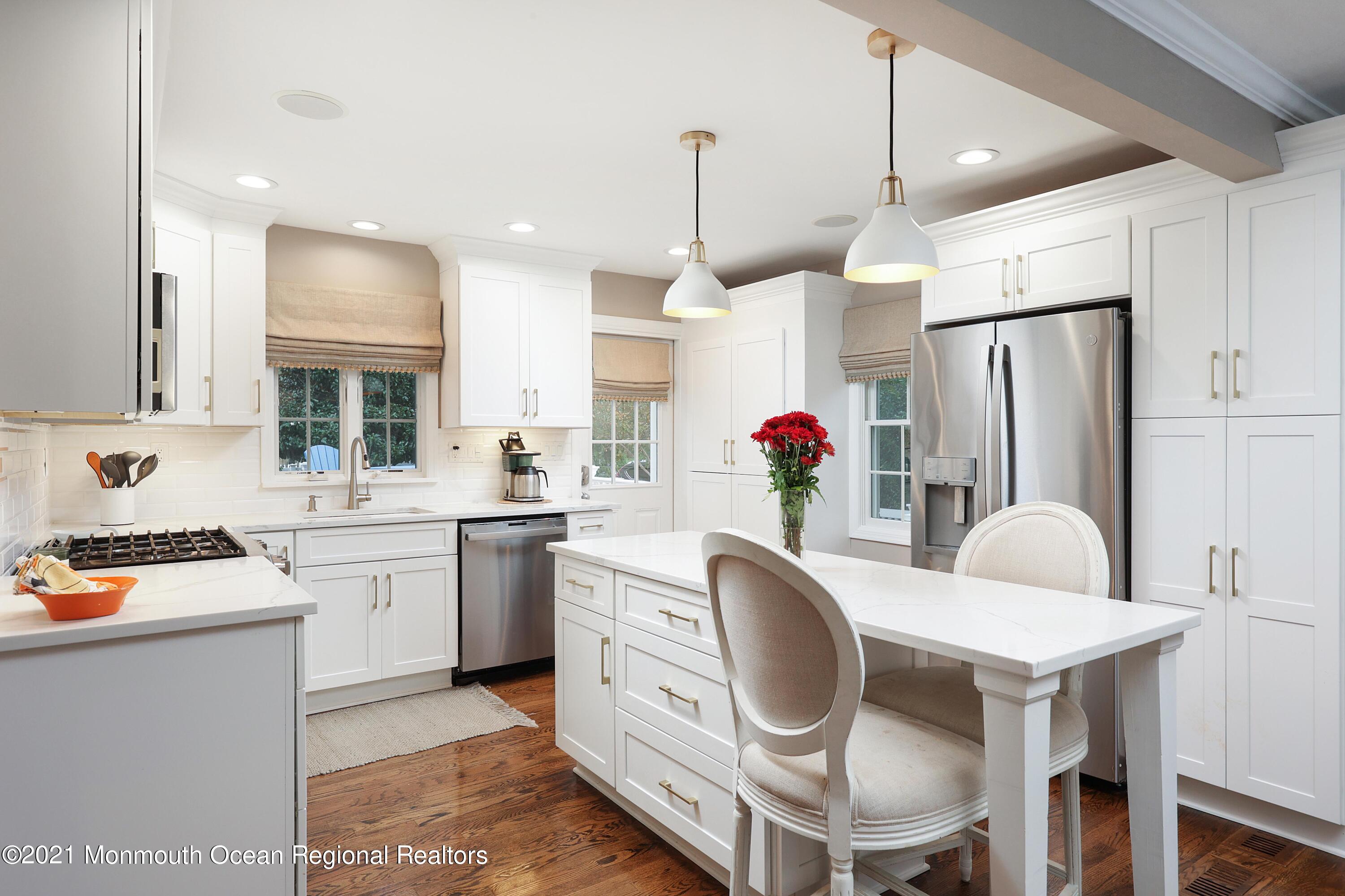 57 River Road Rumson, NJ 07760 - Photo 6 of 34 a kitchen with kitchen island a stove a table and chairs