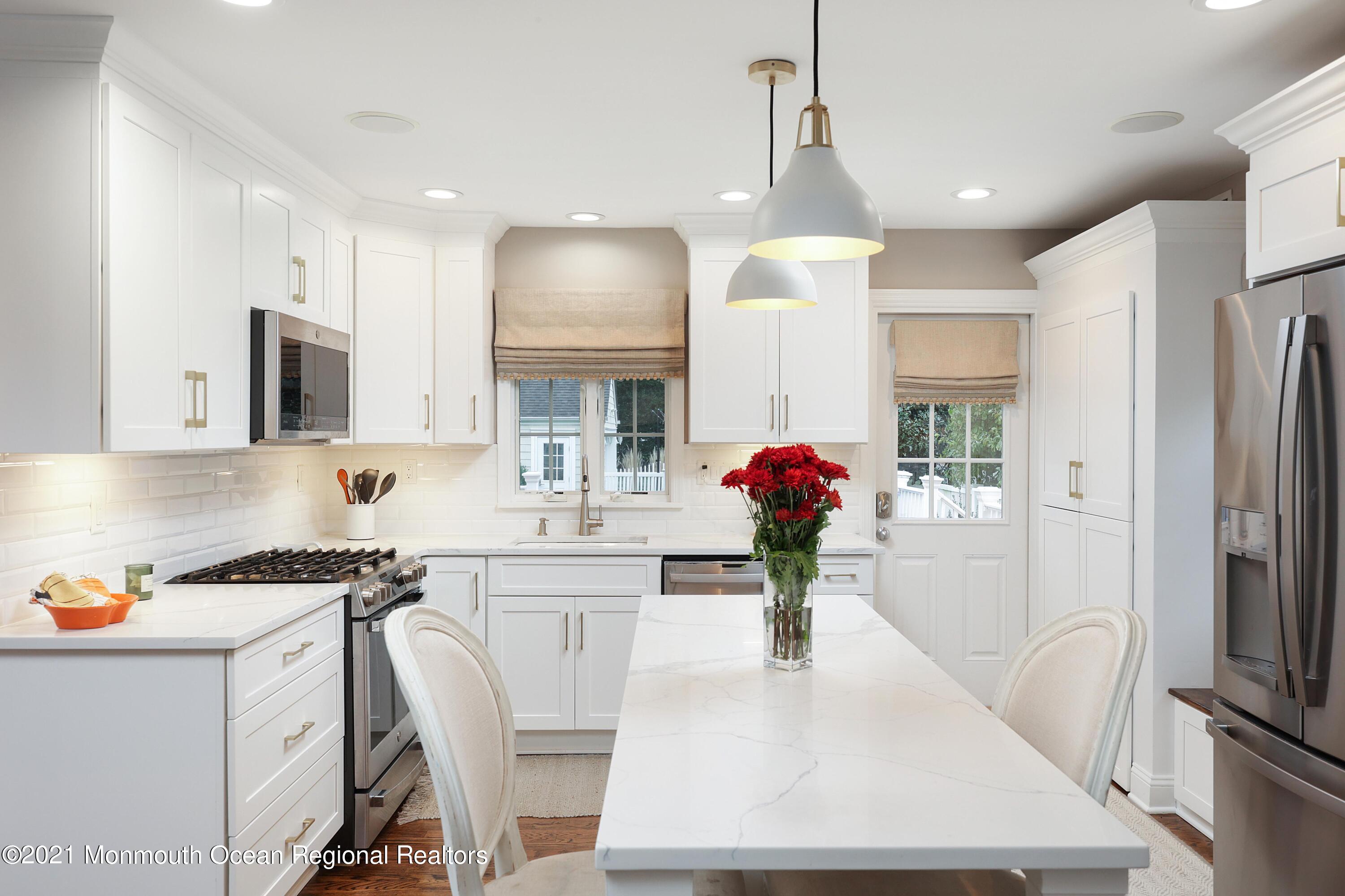 57 River Road Rumson, NJ 07760 - Photo 7 of 34 a kitchen with granite countertop a sink stainless steel appliances and cabinets