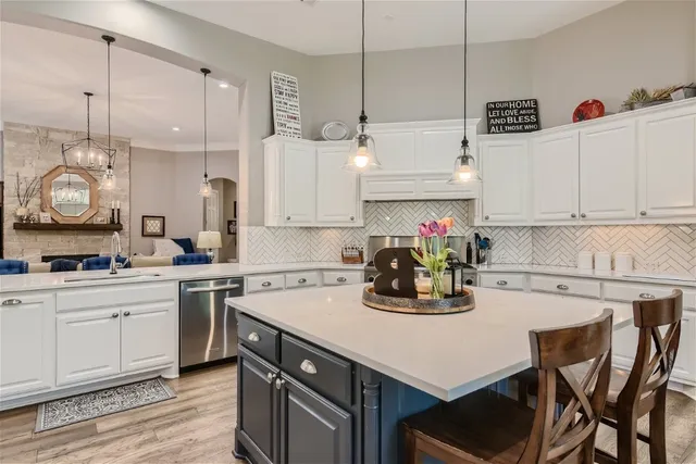 a kitchen with white cabinets and white appliances