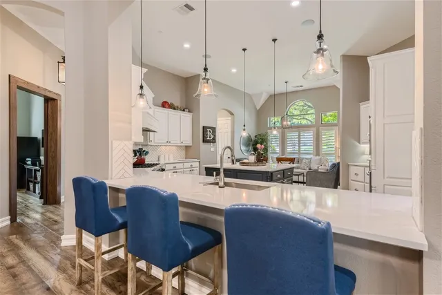 a large kitchen with a table and chairs