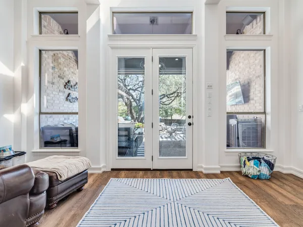 a living room with furniture a rug and a chandelier