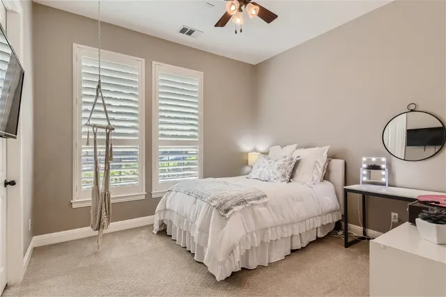 a bedroom with a bed a mirror and a window with the outer view