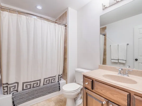 a spacious bedroom with a bed and a couch