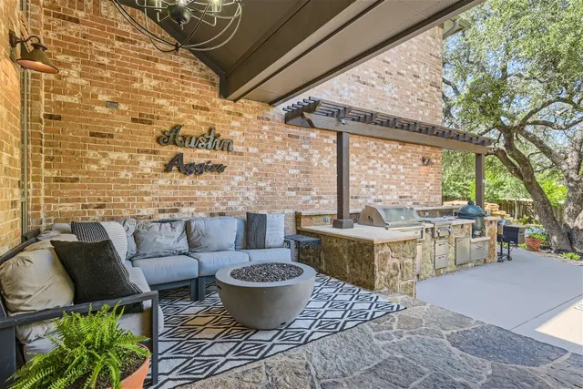 a living room with patio furniture and a potted plant
