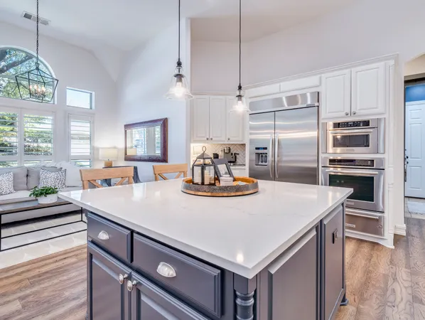 a kitchen with a stove a refrigerator and a wooden cabinets