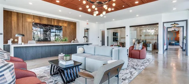 a living room with furniture a window and kitchen view