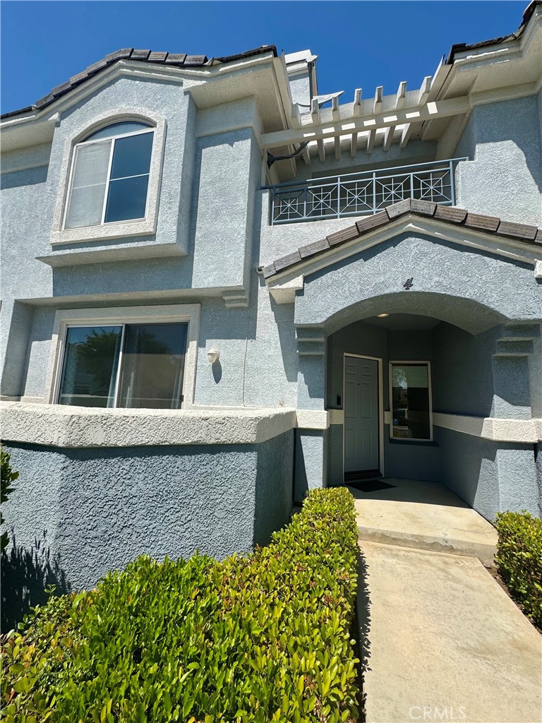 2275 Indigo Hills Drive, Unit 4 Corona, CA 92879 - Photo 1 of 9 a front view of a house with a garage