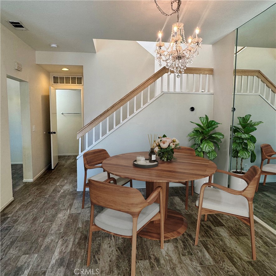 2275 Indigo Hills Drive, Unit 4 Corona, CA 92879 - Photo 3 of 9 a view of a dining room with furniture and wooden floor