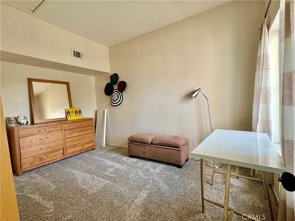 2275 Indigo Hills Drive, Unit 4 Corona, CA 92879 - Photo 7 of 9 a bedroom with a bed and a dresser in it