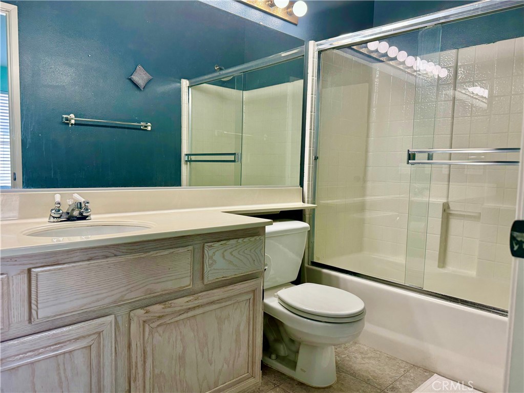 2275 Indigo Hills Drive, Unit 4 Corona, CA 92879 - Photo 8 of 9 a bathroom with a sink a toilet and shower