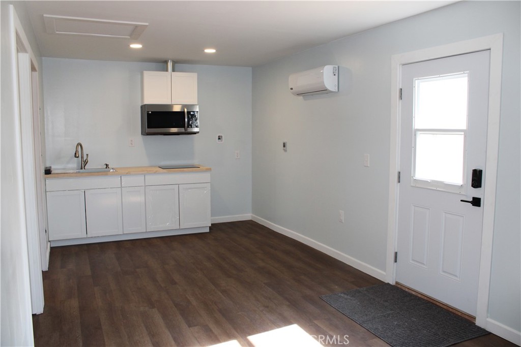 5776 Katherine Street Simi Valley, CA 93063 - Photo 4 of 15 a view of a kitchen with wooden floor and electronic appliances
