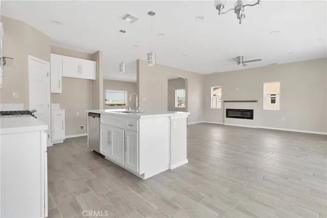 a view of kitchen with sink microwave and cabinets