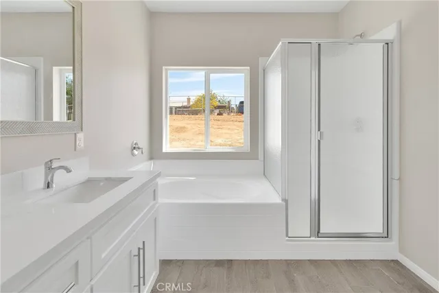 a bathroom with a sink a bathtub and a window