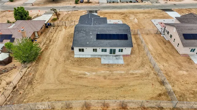 a aerial view of a house with a yard and lake view