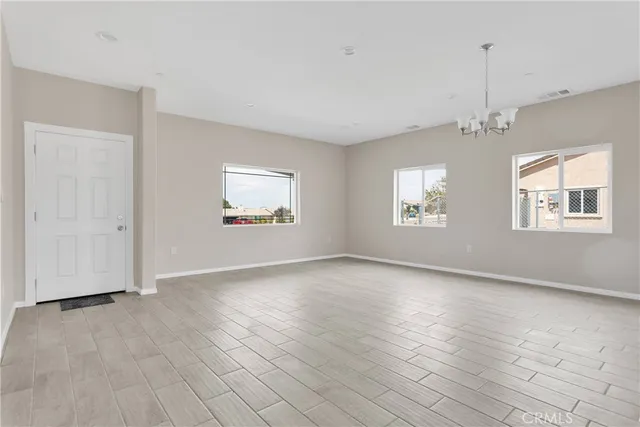 an empty room with windows and closet