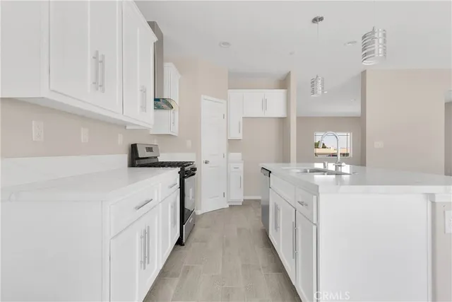 a kitchen with white cabinets