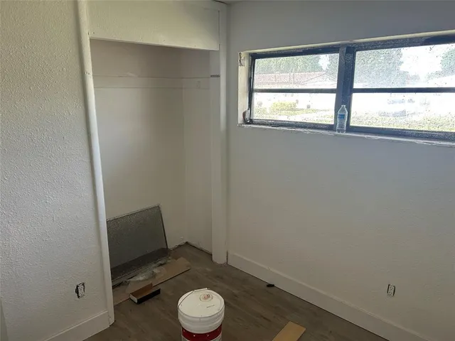 a view of small space with racks on the wall and a window