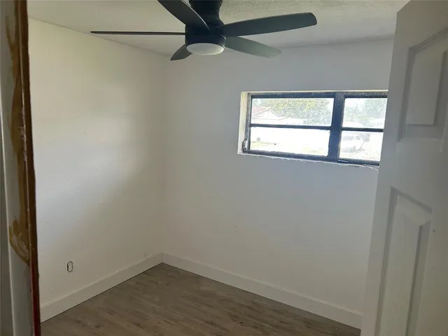 a view of hallway with wooden floor