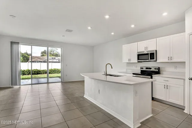 a kitchen with stainless steel appliances granite countertop a sink and a stove