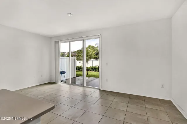 a view of an empty room with glass door