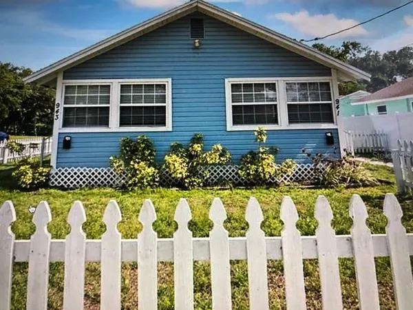 a front view of a house having a garden