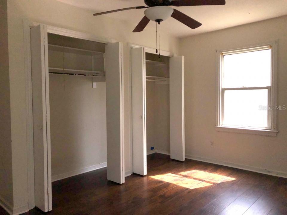 941 Lakeview Road Clearwater, FL 33756 - Photo 14 of 20 a view of an empty room with a window and wooden floor