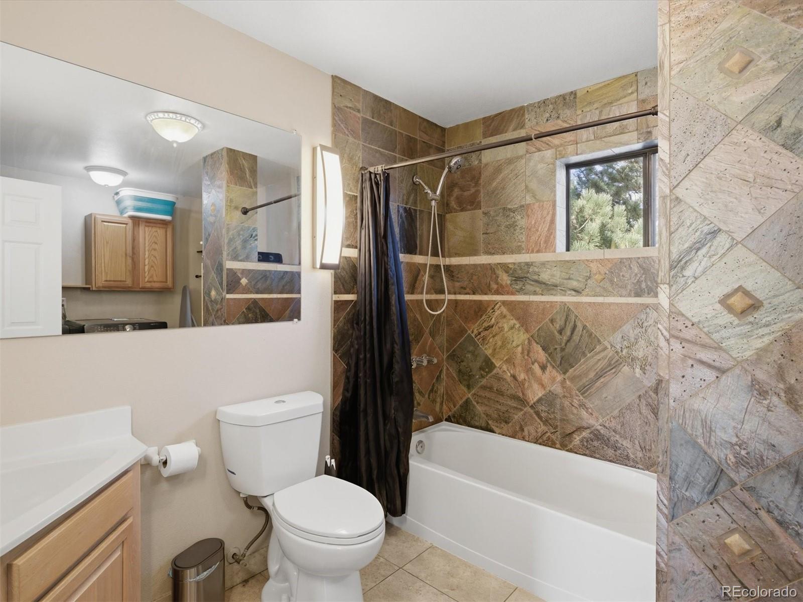 209 Pine Drive Bailey, CO 80421 - Photo 17 of 48 a bathroom with a toilet a sink and bathtub