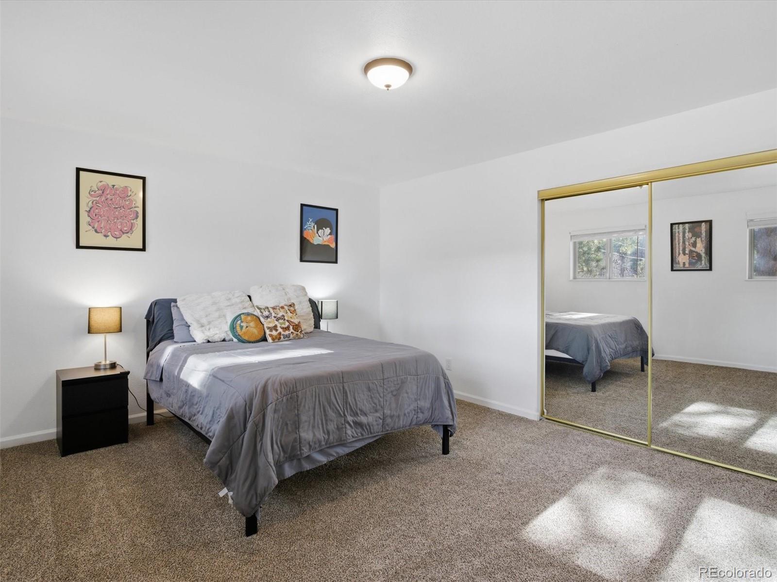 209 Pine Drive Bailey, CO 80421 - Photo 19 of 48 a bed room with a bed and a chair