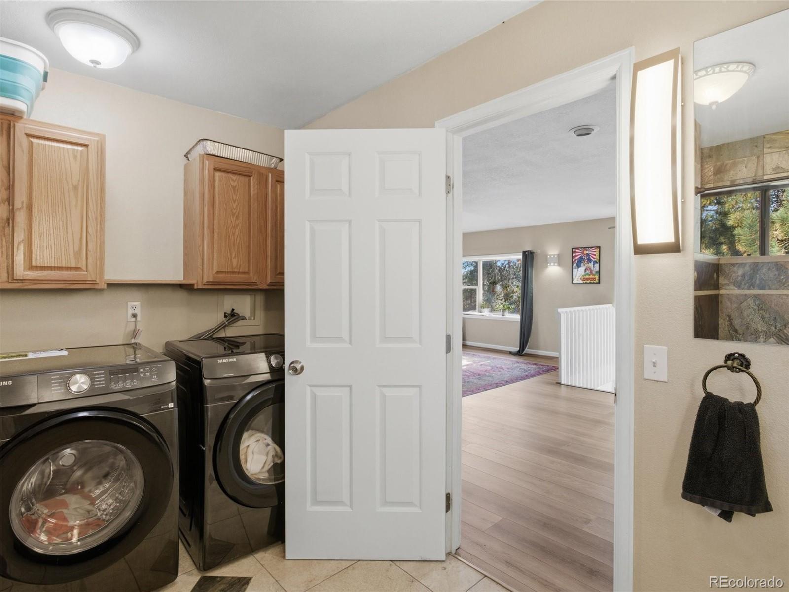 209 Pine Drive Bailey, CO 80421 - Photo 21 of 48 a view of a storage and utility room with washer and dryer