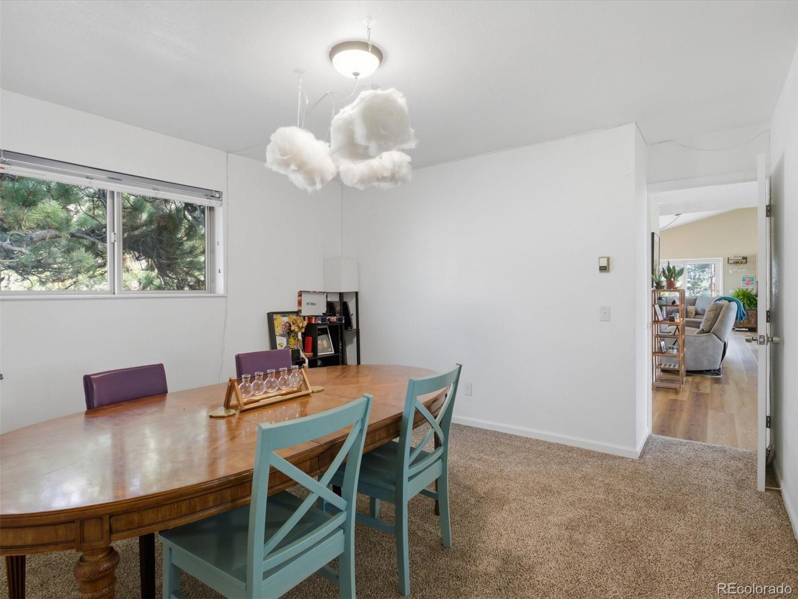 209 Pine Drive Bailey, CO 80421 - Photo 22 of 48 a view of a dining room with furniture and a chandelier