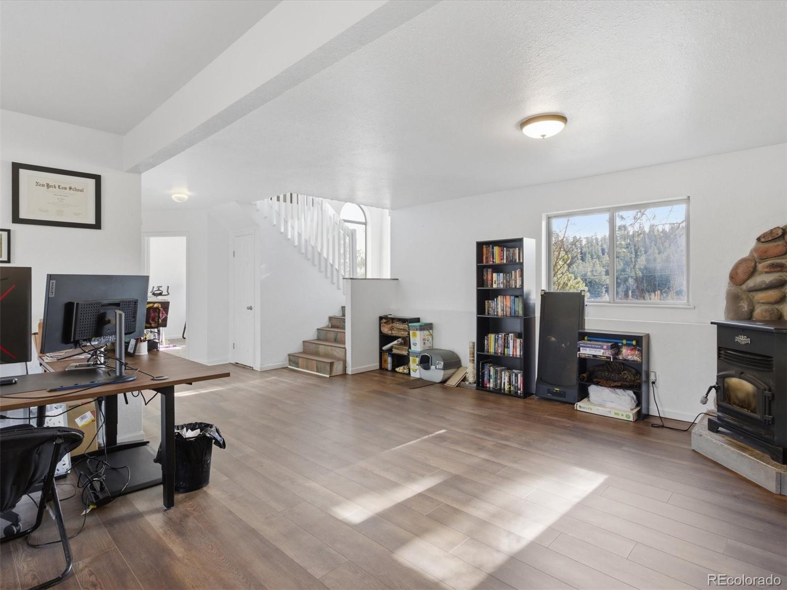 209 Pine Drive Bailey, CO 80421 - Photo 26 of 48 a view of a workspace with furniture and a livingroom