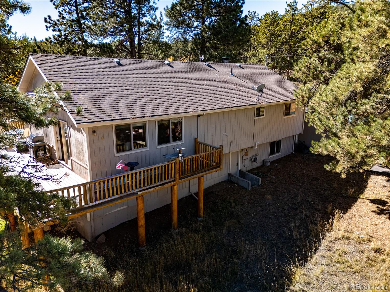 209 Pine Drive Bailey, CO 80421 - Photo 33 of 48 a view of house with garden and deck