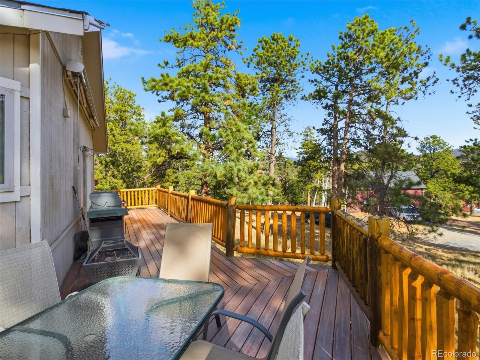 209 Pine Drive Bailey, CO 80421 - Photo 6 of 48 a view of a chairs and table in the balcony
