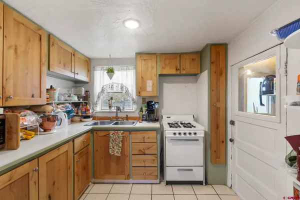 a kitchen with a sink window and cabinets