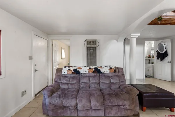 a large bedroom with a bed and a couch