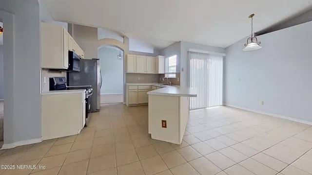 a kitchen with cabinets and a stove top oven