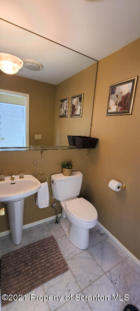 129 Bald Mountain Road Wilkes Barre, PA 18702 - Photo 24 of 40 a bathroom with a toilet a sink and mirror