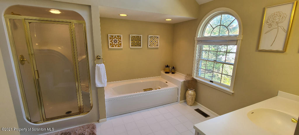 129 Bald Mountain Road Wilkes Barre, PA 18702 - Photo 29 of 40 a bathroom with a tub a window and glass door shower