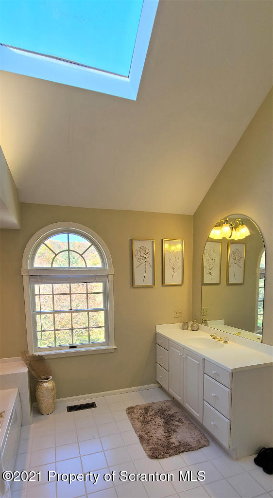 129 Bald Mountain Road Wilkes Barre, PA 18702 - Photo 31 of 40 a bathroom with a sink a mirror and a bathtub