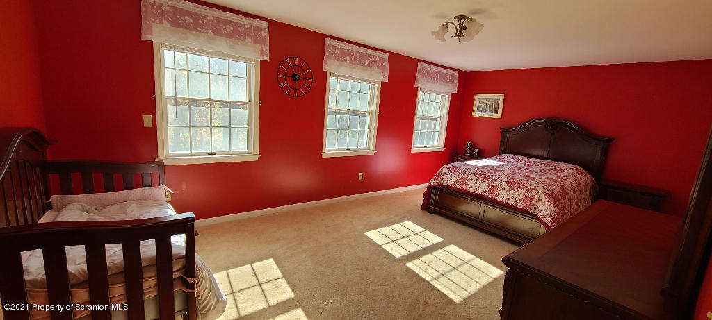 129 Bald Mountain Road Wilkes Barre, PA 18702 - Photo 32 of 40 a bedroom with a bed and wooden floor