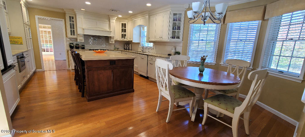 129 Bald Mountain Road Wilkes Barre, PA 18702 - Photo 8 of 40 a kitchen with a dining table chairs and refrigerator