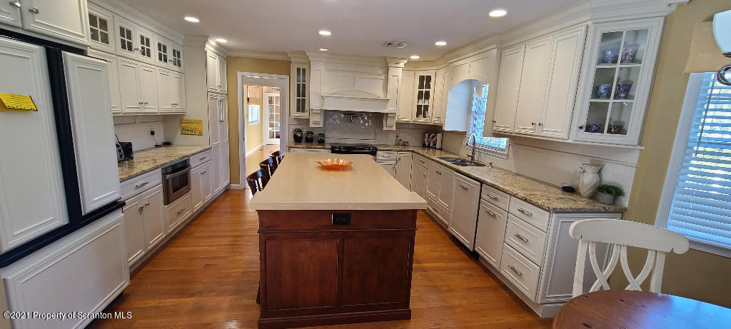 129 Bald Mountain Road Wilkes Barre, PA 18702 - Photo 9 of 40 a kitchen with stainless steel appliances granite countertop wooden cabinets sink and stove