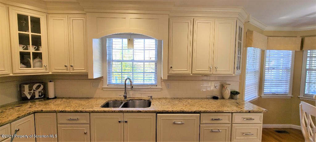 129 Bald Mountain Road Wilkes Barre, PA 18702 - Photo 10 of 40 a kitchen with granite countertop stainless steel appliances white cabinets and a window